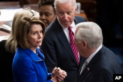 House Minority Leader Nancy Pelosi, center, Vice President Joe Biden, left, and Democratic Congressman Steny Hoyer talk after a joint session of Congress on Capitol Hill in Washington, Jan. 6, 2017.