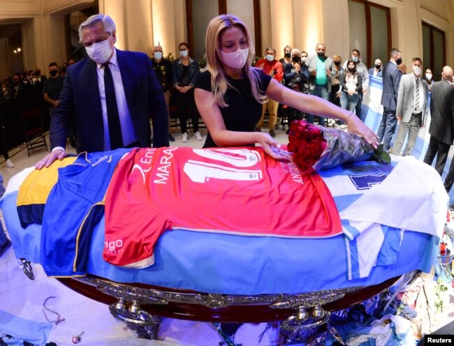 Ibu negara Argentina, Fabiola Yanez meletakkan bunga di peti jenazah legenda sepak bola Diego Maradona, didampingi Presiden Argentina Alberto Fernandez di Istana Presiden Casa Rosada, di Buenos Aires, Argentina, 26 November 2020.