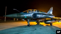 FILE - This photo released Nov. 9, 2015, by the French Army shows a French Mirage 2000 jet on the tarmac of an undisclosed air base. 