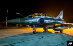 This photo released Nov. 9, 2015, by the French Army shows a French Mirage 2000 jet on the tarmac of an undisclosed air base as part of France's Operation Chammal launched in September 2015 in support of the U.S-led. coalition against Islamic State group.