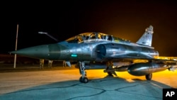 FILE - This photo released Nov. 9, 2015, by the French Army shows a French Mirage 2000 jet on the tarmac of an undisclosed air base as part of France's Operation Chammal launched in September 2015 in support of the U.S-led. coalition against Islamic State group.