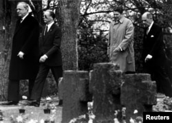 FILE German Chancellor Helmut Kohl walks with retired German Air Force General Johannes Steinhoff (frt) and former President Ronald Reagan accompanied by retired U.S. General Matthew Ridgway through the German military cemetary in Bitburg, May 5 1985.