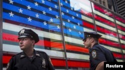 FILE - Police officers patrol Times Square in New York City, July 2015. 