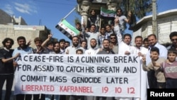 Residents hold a banner during a protest against Syria's President Bashar al-Assad in Kafranbel near Idlib October 19, 2012.