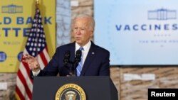 FILE - President Joe Biden gestures as he delivers remarks on the importance of COVID-19 vaccine requirements, during a visit at a Clayco construction site, in Elk Grove Village, Illinois, Oct. 7, 2021. 