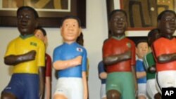 Osso Reine's Johannesburg art shop stocks wooden figurines made specially for the World Cup by her relatives in Abidjan
