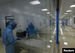 Employees work at the pharmaceutical plant of Lupin, India's No. 2 drugmaker, in Verna, in the western state of Goa, India, June 9, 2017.