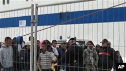 Would-be migrants believed to be from Tunisia at the port of the Sicilian island of Lampedusa, February 11, 2011