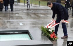 Polish Prime Minister Mateusz Morawiecki lays a wreath as he visits the Ulma Family Museum of Poles Who Saved Jews during WWII, in Markowa, Poland, Feb. 2, 2018.