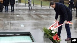 Polish Prime Minister Mateusz Morawiecki lays a wreath as he visits the Ulma Family Museum of Poles Who Saved Jews during WWII, in Markowa, Poland, Feb. 2, 2018. 