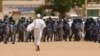 Anti-government protestor faces riot police last week in Khartoum. (A. Ahmed/VOA)