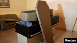 A cardboard coffin is seen at a mortuary in Valencia, in the state of Carabobo, Venezuela, Aug. 25, 2016.