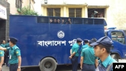 Two co-convicts in a graft case against Bangladesh opposition leader Khaleda Zia in Dhaka look out from a prison van at the premises of a special court in Dhaka on October 29, 2018.