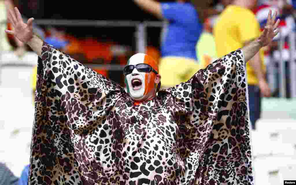 A fan of Ivory Coast cheers before the start of the match against Greece at the Castelao arena in Fortaleza, June 24, 2014.