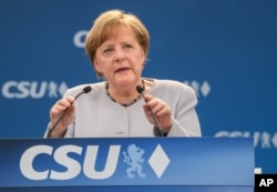 FILE - German Chancellor Angela Merkel delivers a speech during a joint campaigning event of the Christian Democratic Union (CDU) and the Christion Social Union (CSU) in Munich, May 27, 2017.