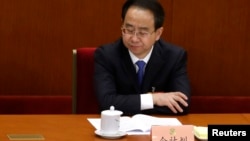 FILE - Ling Jihua pauses while attending the opening ceremony of the Chinese People's Political Consultative Conference (CPPCC) at the Great Hall of the People in Beijing, March 3, 2013.