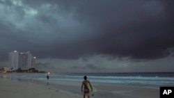 Clouds gather over Playa Gaviota Azul as Tropical Storm Zeta approaches Cancun, Mexico, early Monday morning, Oct. 26, 2020.