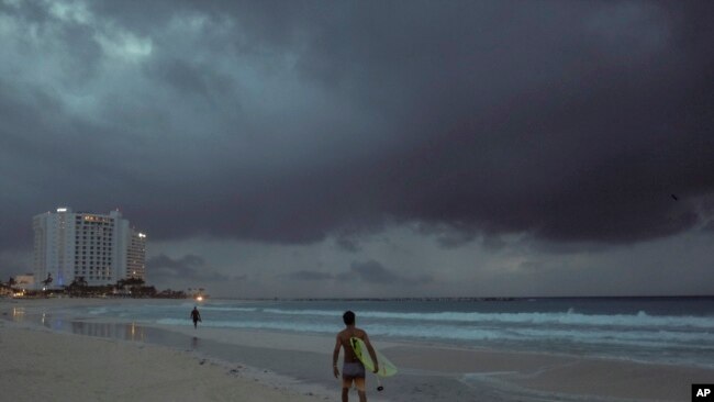 Clouds gather over Playa Gaviota Azul as Tropical Storm Zeta approaches Cancun, Mexico, early Monday morning, Oct. 26, 2020.