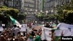 People march to protest against President Abdelaziz Bouteflika's plan to extend his 20-year rule by seeking a fifth term in April elections in Algiers, Algeria, March 1, 2019.