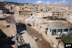FILE - A general view shows damaged buildings in the town of Darat Azzah, west of the northern Syrian city of Aleppo, following reported bombings by government forces, Oct. 7, 2015.