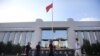 Police patrol at the gate of Kunming's Intermediate Court in Kunming, southwest China's Yunnan province, Sept. 12, 2014. 