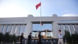 Police patrol at the gate of Kunming's Intermediate Court in Kunming, southwest China's Yunnan province, Sept. 12, 2014. 
