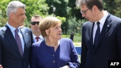 From left, President Hashim Thaci, German Chancellor Angela Merkel and Serbian President Aleksandar Vucic speak prior to the family photo during an EU-Western Balkans Summit in Sofia, May 17, 2018. 