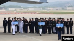 U.N. honor guards carry small boxes containing remains believed to be from American servicemen killed during the 1950-53 Korean War after they arrived from North Korea, at Osan Air Base in Pyeongtaek, South Korea, July 27, 2018. 