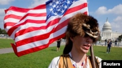 A man wearing a raccoon hat talks about his belief that Donald Trump won the election during a rally in support of defendants being prosecuted in the Jan. 6 attack on the Capitol, in Washington, Sept. 18, 2021. 