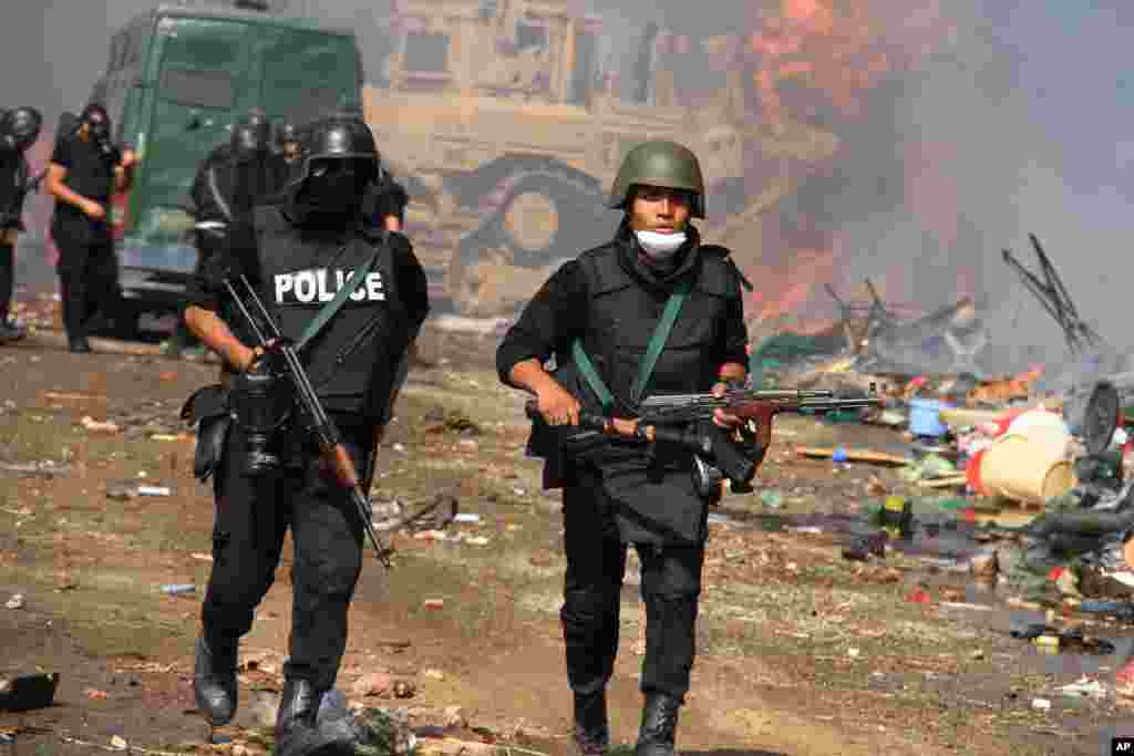 Egyptian security forces clear a sit-in camp set up by supporters of ousted President Mohamed Morsi in Nasr City district, Cairo, Egypt, Aug. 14, 2013.