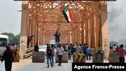 Sudanese people protest against a military coup overthrowing the transition to civilian rule on Oct. 25, 2021 in the capital Khartoum's twin city of Omdurman.