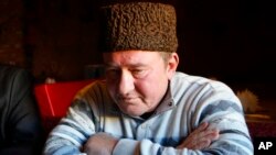 FILE – Crimean Tatar activist Ilmi Umerov listens for a journalist's question during an interview with the Associated Press in Simferopol, Crimea, Jan. 25, 2016.