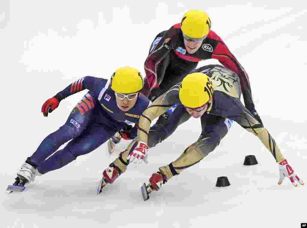 Sakashita Satoshi of Japan, right, skates besides Torsten Kroeger of Germany, center, and Kwak-Yoon-Gy of South Korea, left, during the men&#39;s 500 meters quarterfinal race at the World Cup short track speed skating championship in Dresden, Germany.