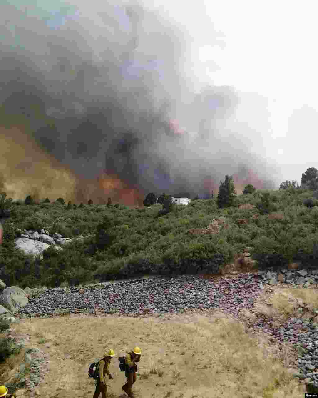 A wildfire burns homes in Yarnell, Arizona, June 30, 2013.