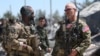 FILE - U.S. forces are seen at the Kurdish People's Protection Units (YPG) headquarters after it was hit by Turkish airstrikes in Mount Karachok near Malikiya, Syria, April 25, 2017. 