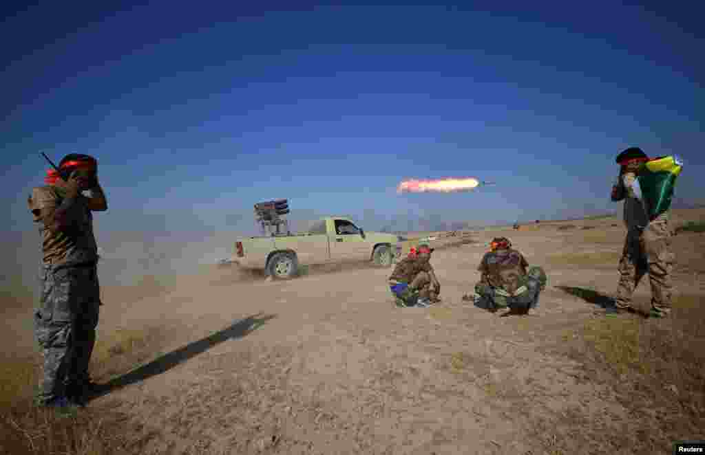 Shi&#39;ite Popular Mobilization Forces (PMF) launch a rocket towards Islamic State militants on the outskirts of Tal Afar, Iraq.