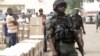 A police officer stands guard as electoral workers load ballot papers into trucks to be transported to polling stations, at the Independent National Electoral Commission in Yola, Nigeria, Feb. 15, 2019.