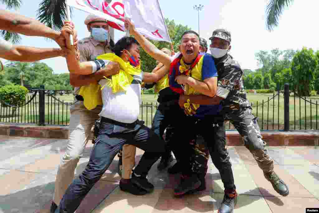 Police officers detain Tibetan demonstrators during a protest against Chinese Communist Party&#39;s 100-year anniversary celebrations, outside Chinese Embassy in New Delhi, India.