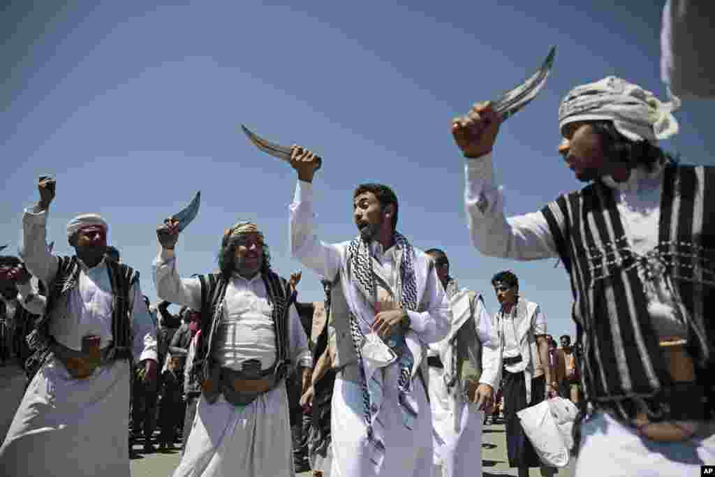 A Yemeni prisoner, center, performs a traditional dance during his arrival after being released by the Saudi-led coalition at the airport in Sanaa, Yemen, Friday, Oct. 16, 2020. Yemen&#39;s warring sides completed a major, U.N.-brokered prisoner swap on Frida