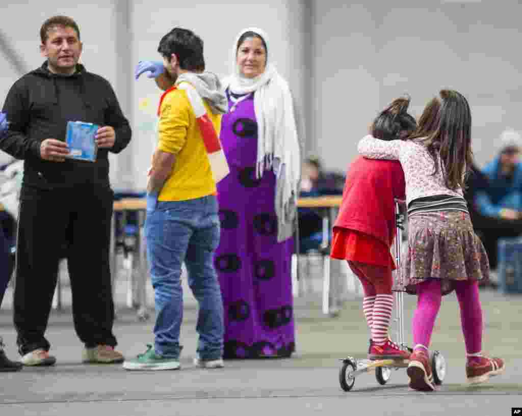 Childrens play in the accommodation, at the exhibition halls of the trade fair Messe Erfurt, in Erfurt, central Germany. More than 700 refugees are living there at the moment.