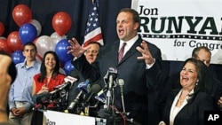 Wife Loretta Runyan, second left, and their son Jon Runyan Jr., left, look on as Republican Jon Runyan gestures while celebrating at his victory party after being elected for New Jersey's 3rd Congressional District, 02 Nov 2010