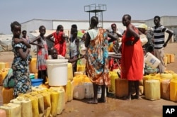 FILE - Residents of a camp for the internally displaced line up to get water from a borehole, on the outskirts of Juba, South Sudan, Jan. 22, 2019.