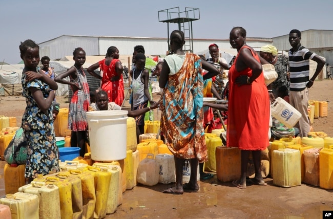 FILE - Residents of a camp for the internally displaced line up to get water from a borehole, on the outskirts of Juba, South Sudan, Jan. 22, 2019.
