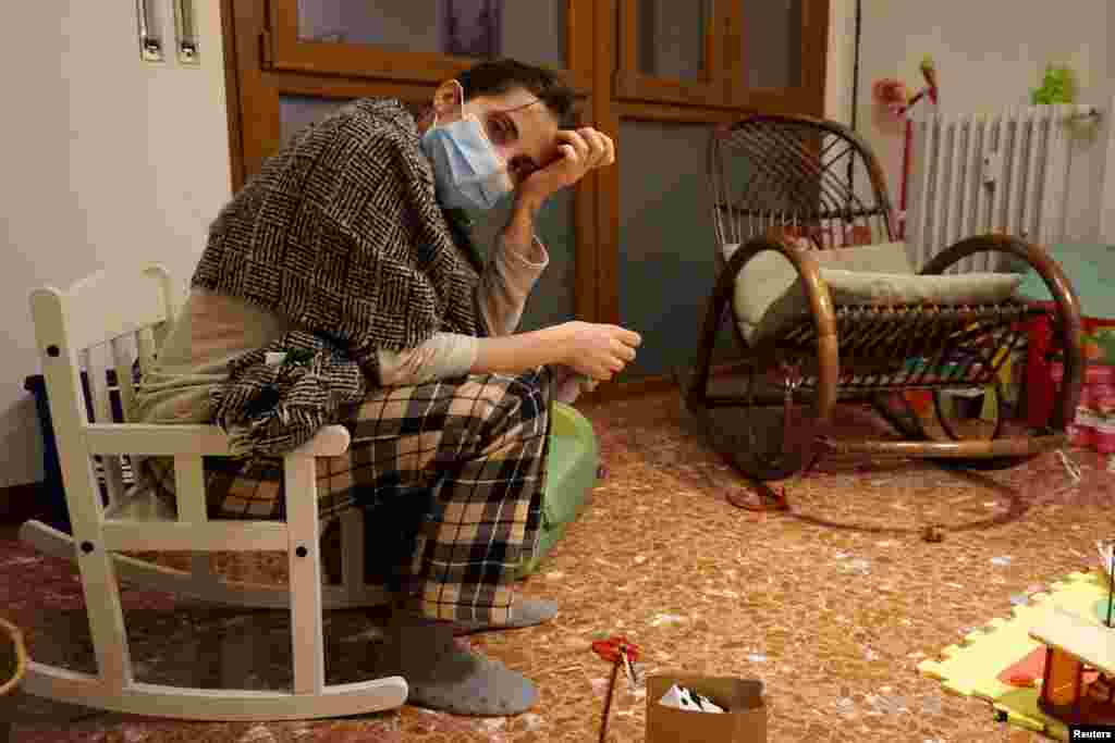 Italian doctor Cecilia Bartalena, 35, rests as she returns home from a long shift in the emergency ward at the Cisanello hospital, in this picture taken by her husband, musician Lorenzo Marianelli, in Pisa, Italy.