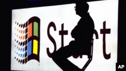 FILE - In this Aug. 24, 1995 file photo, Microsoft Chairman Bill Gates sits on stage during a video portion of the Windows 95 Launch Event on the company's campus in Redmond, Washington.