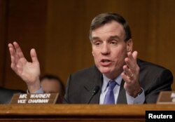 FILE - Senator Mark Warner, D-VA, questions witnesses during a Senate Select Committee on Intelligence hearing on Russia’s intelligence activities on Capitol Hill in Washington, D.C., Jan. 10, 2017.