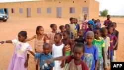 FILE - Children get ready to enter a class room in Yakouta, Burkina Faso. 