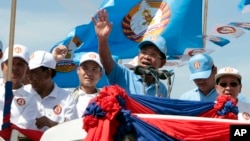 Cambodian Prime Minister Hun Sen, center, of the Cambodian People's Party (CPP), waves from a truck as he leads a rally in Phnom Penh, Cambodia, June 2, 2017. Early results show the from the June 4 commune poll show the CPP in a solid lead over competitor