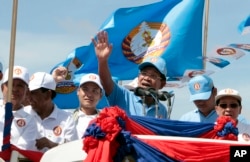 FILE - Cambodian Prime Minister Hun Sen, center, of the Cambodian People's Party (CPP), waves from a truck as he leads a rally in Phnom Penh, Cambodia, June 2, 2017.