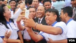 CPP supporters take a selfie with Heng Samrin, National Assembly president attends the 65th annual celebration of ruling party Cambodian People's Party (CPP) establishment on Tuesday, June 28, 2016, at CPP's headquarter in Phnom Penh. (Leng Len/VOA Khmer) 